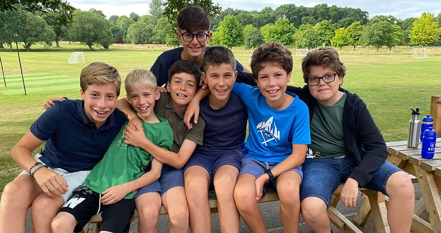 A group of happy children smile at the camera on their residential English summer school