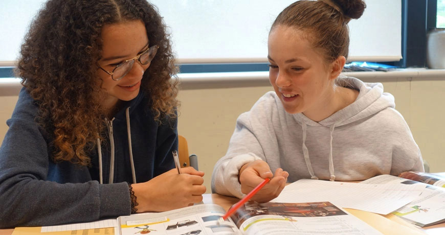 Teenagers studying English together on their summer boarding course