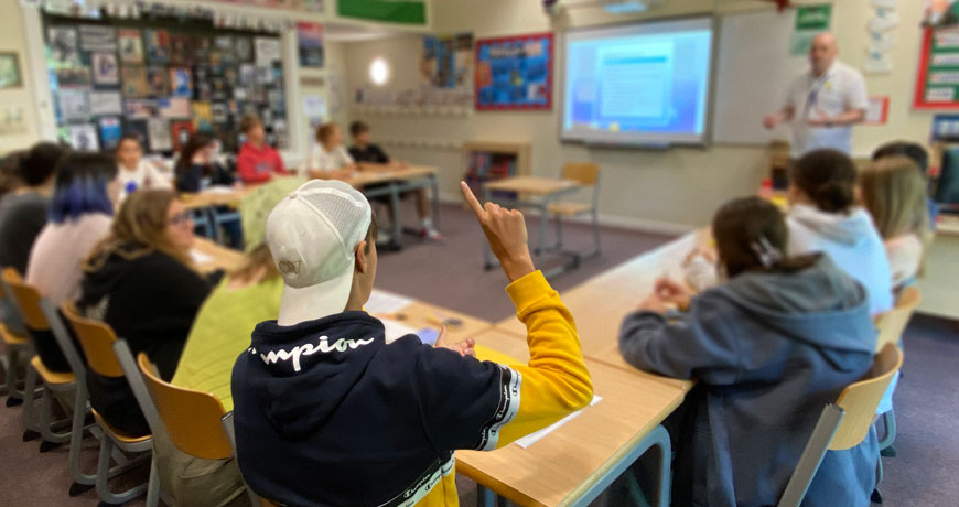 An ECS English language classroom with teenagers engaged and asking questions